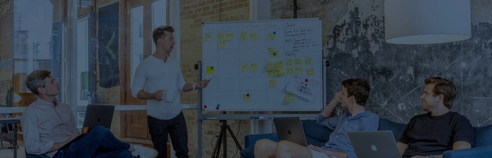 Team workshop with a facilitator presenting at a whiteboard